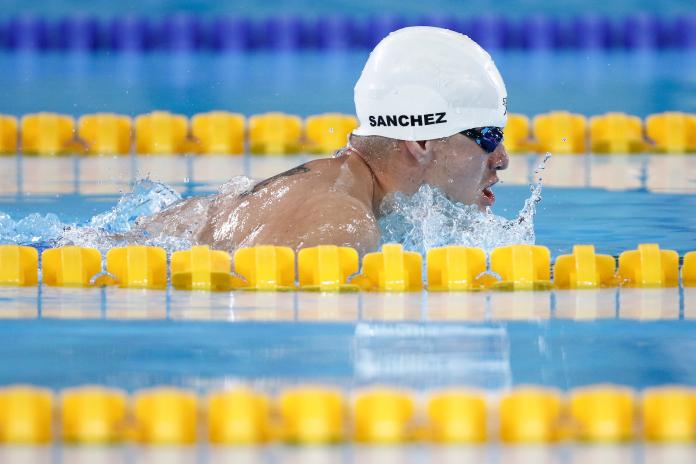 a male Para swimmer doing a breaststroke in the pool