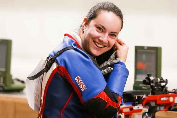 female Para shooter smiles at the camera