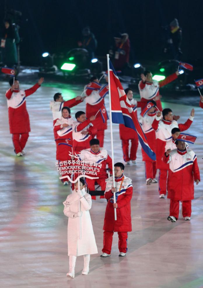 a group of Para athletes walking at an opening ceremony