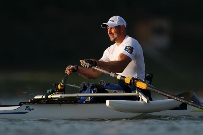 Man in row boat looks on