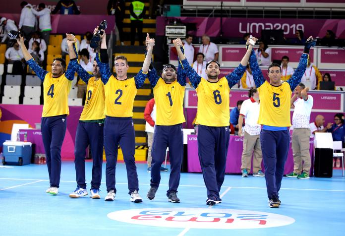 Brazilian goalball players lifting their arms to celebrate after winning the Lima 2019 competition