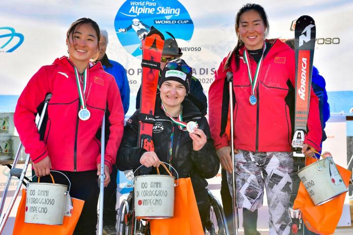 Three female sit-skiers on the podium