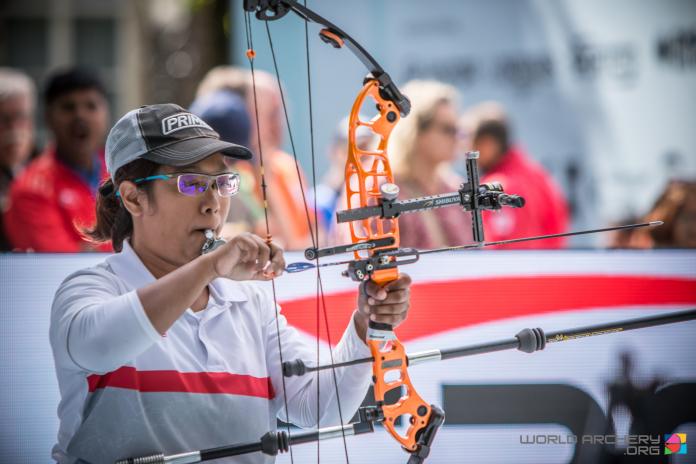 Signapore female archer prepares her bow and arrow