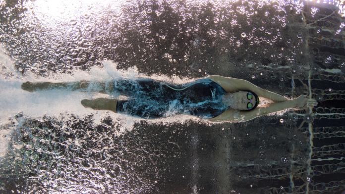 An underwater image of a female Para swimmer with one leg