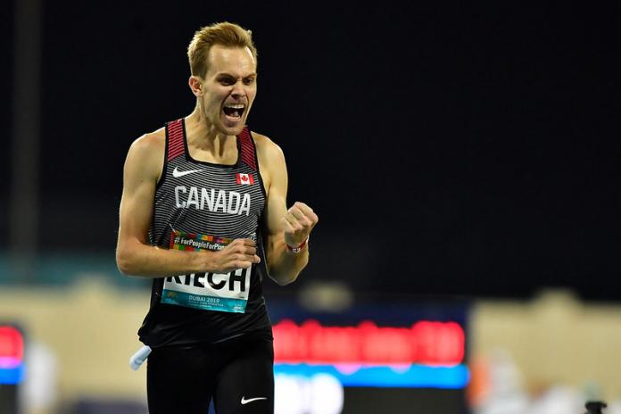 Canadian male distance runner celebrates