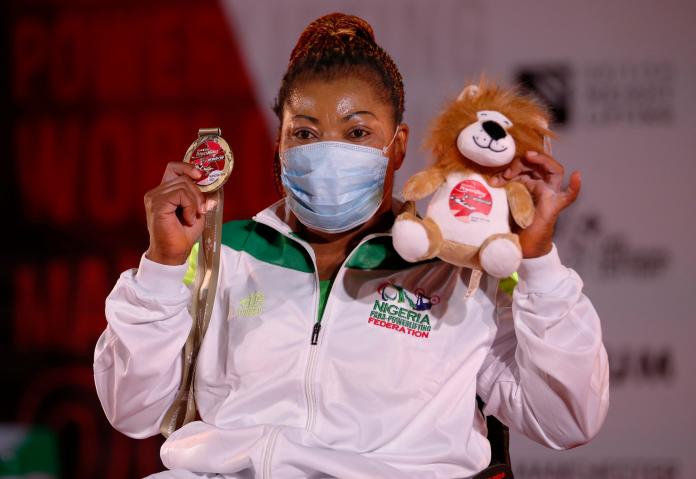 Lucy Ejike poses with her gold medal after winning in Manchester