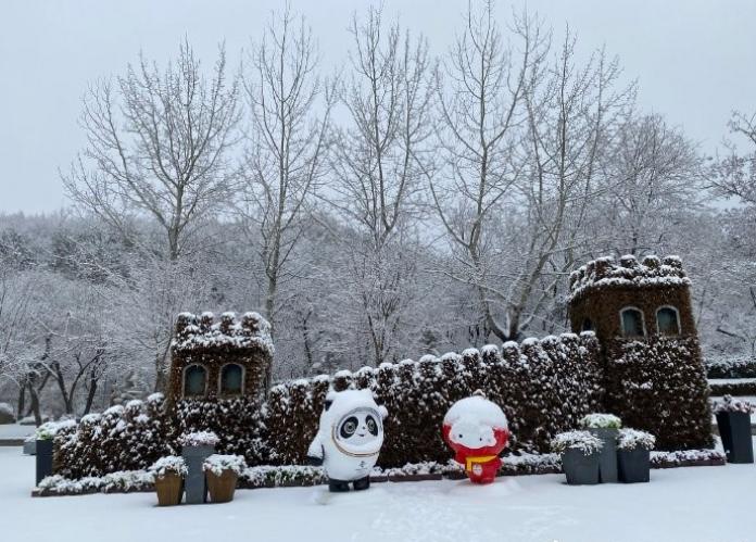 Snow covered scene with Beijing 2022 mascots