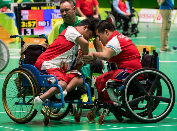 Two Thai boccia athletes shake hands