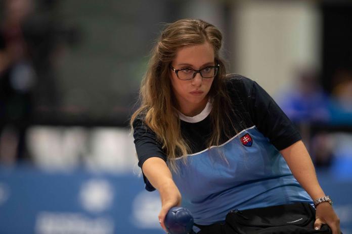 Female boccia player concentrates before throwing the ball