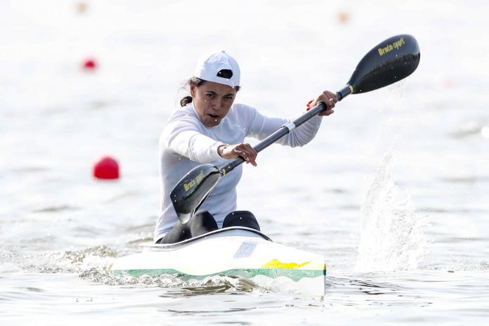 Woman paddles in canoe