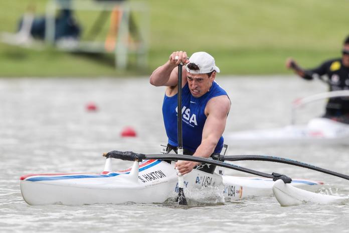 Man in va'a boat racing hard