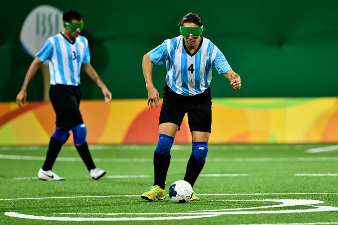 Blind soccer player dribbling a ball