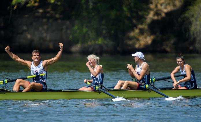 British mixed coxed four team celebrate after finishing a race