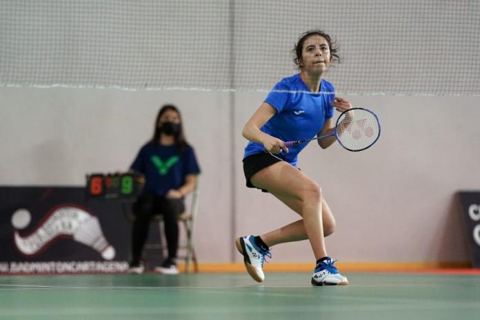 Portuguese Para badminton player Inoi Ferreira waits and gets ready to hit the shuttlecock on the other side of the net