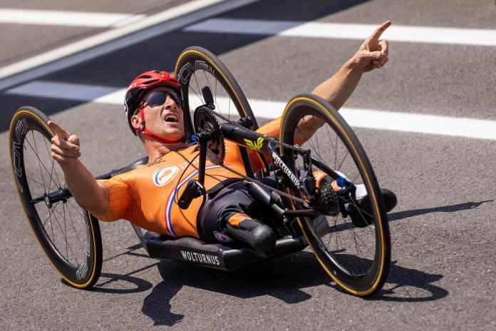Dutch handcyclist celebrates after crossing finish line