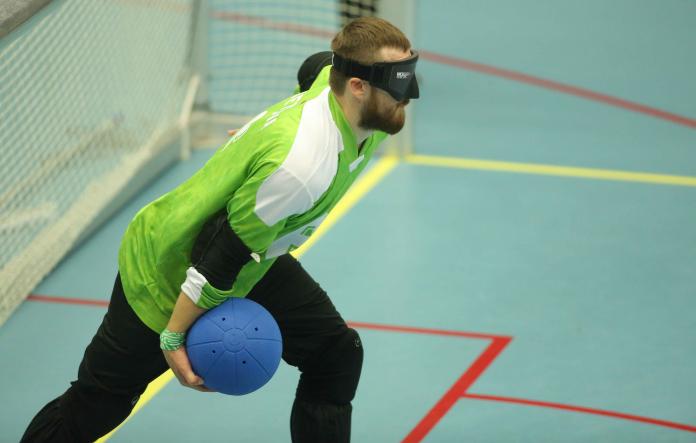 Lithuanian man with goalball prepares to throw it
