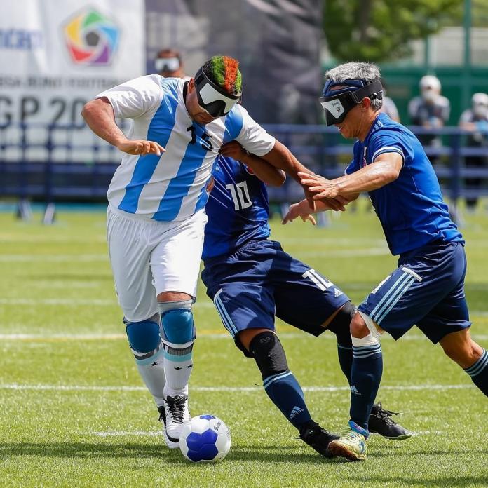 Argentinian blind footballer dribbles the ball past defenders