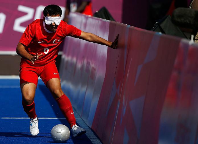 Turkish blind footballer touches the side boards