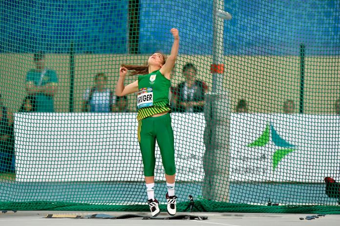 South African Para athlete Simone Kruger in the air after throwing the discus