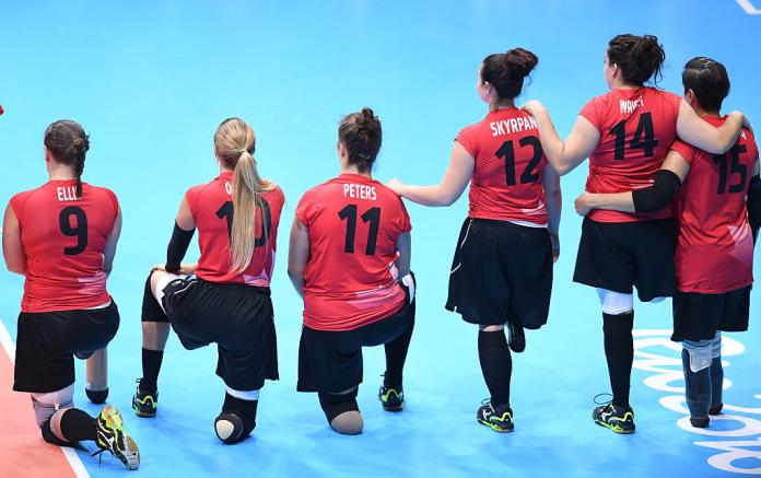 Women's sitting volleyball players line up