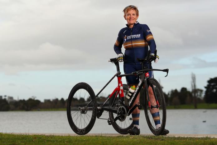 Woman poses next to her tricycle