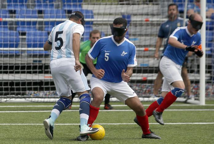 Blind French football tries to defend his opponent