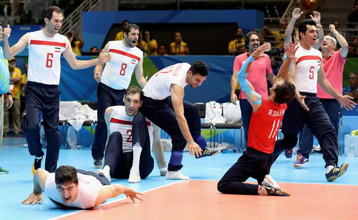 Iranian men's sitting volleyball team celebrate winning gold on the court