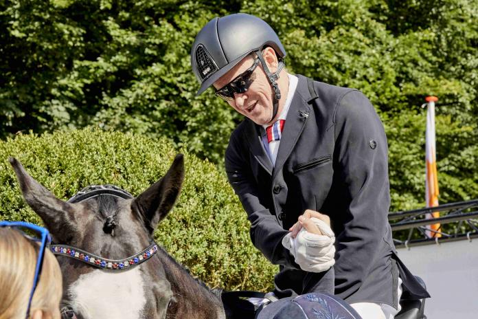 Man on horse is congratulated 