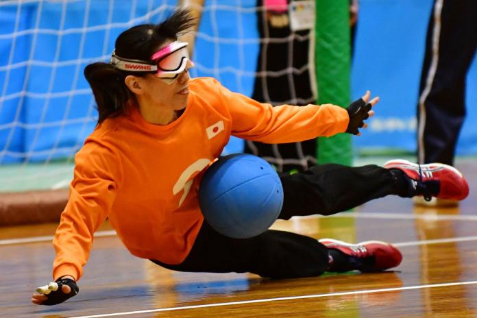 A Japanese goalball player stops the ball from entering the goal