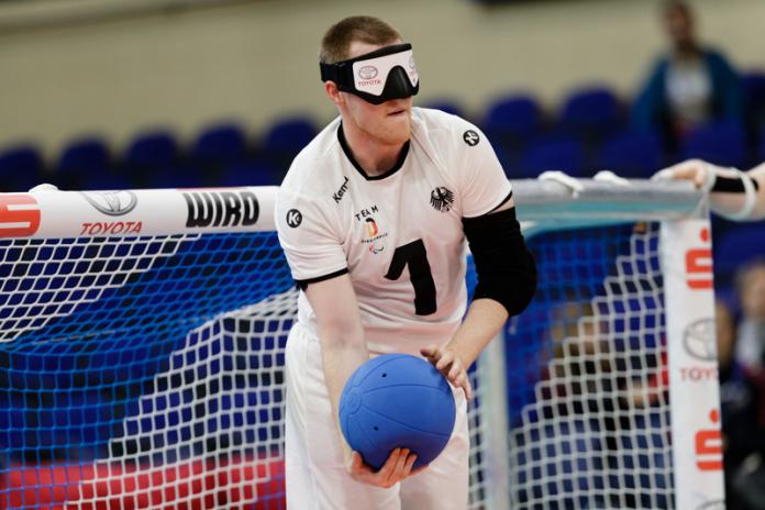 German male goalballer prepares to throw the ball