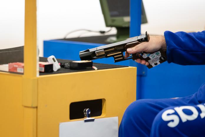 Hand holding a pistol in shooting Para sport