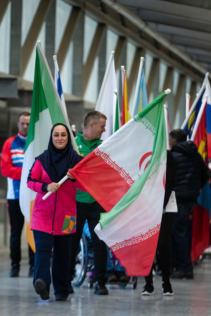 Iranian woman carries Iranian flag