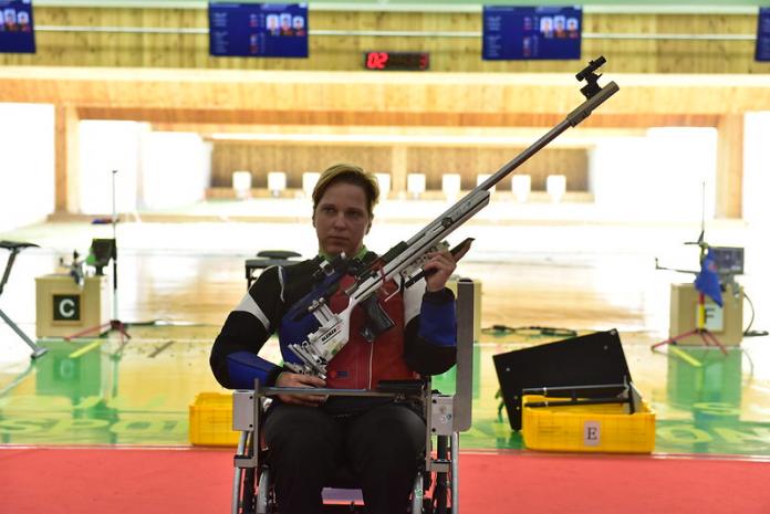 Woman holds rifle