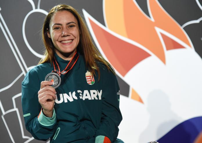 Eva Andreja Hajmasi with Hugarian gear smiles to the camera while holding her silver medal