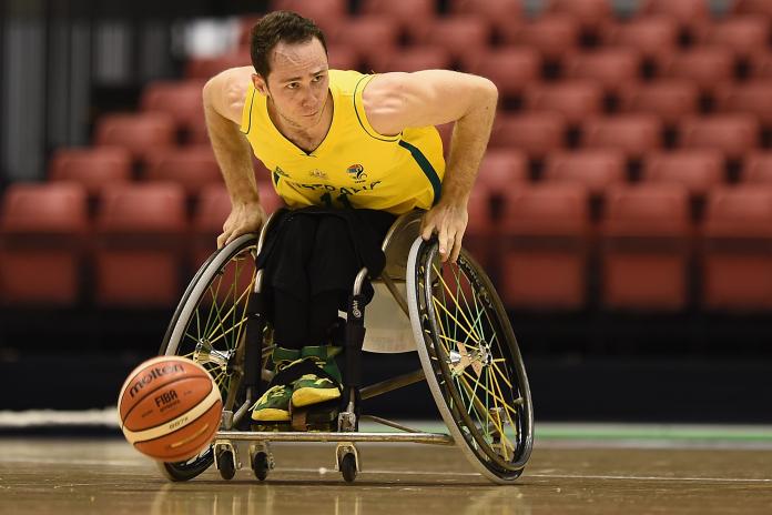 Tom O’Neill-Thorne moves forward with his wheelchair and the basketball ahead of him