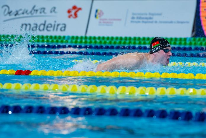 Male swimmer emerges from waters