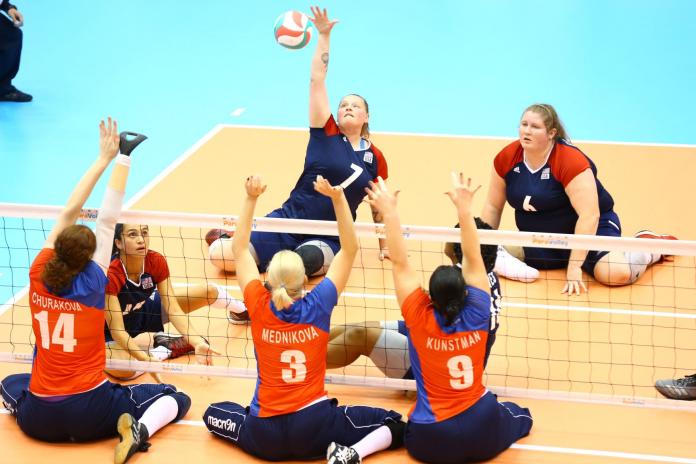 Woman hits volleyball