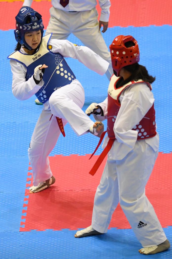 Two women competing in Para taekwondo