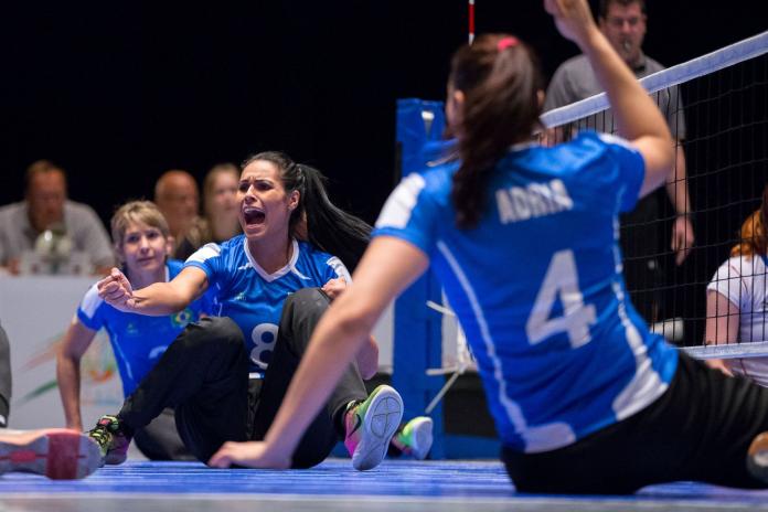 Female sitting volleyball player celebrates after a point