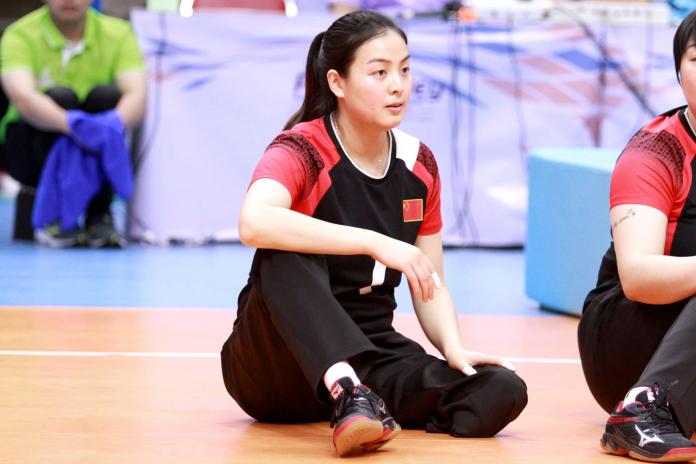 Chinese female sitting volleyball player waits on the court