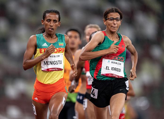 Two women leading a race followed by competitors