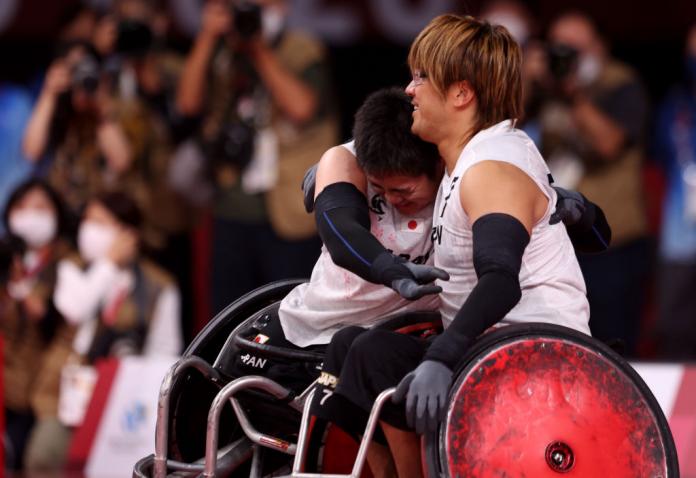 Katsuya Hashimoto and Daisuke Ikezaki of Japan embrace after defeating Australia 