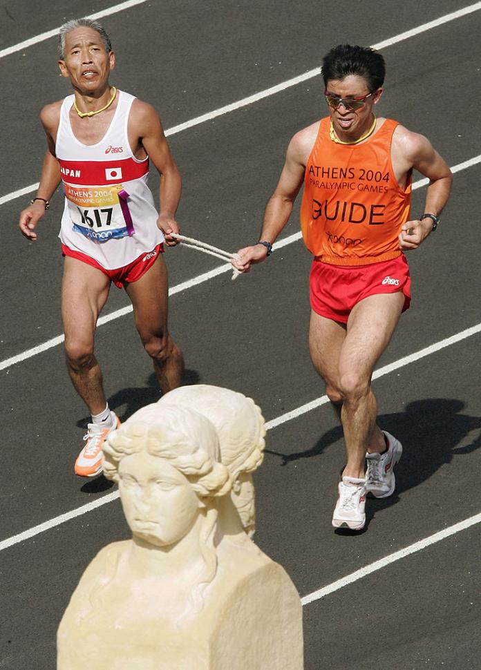 Japanese blind runner tethered to his guide