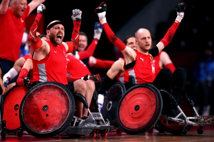 Danish wheelchair rugby players celebrateLeon Joergensen of