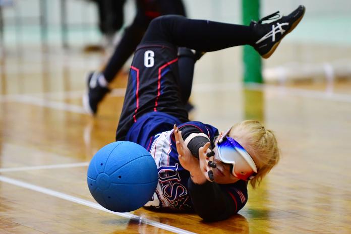 US goalball player Marybai Huking throws herself into the floor to stop a ball