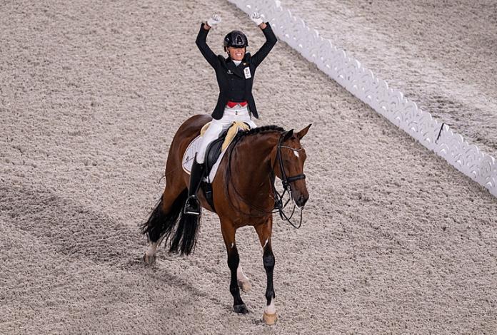 Woman celebrates on her horse