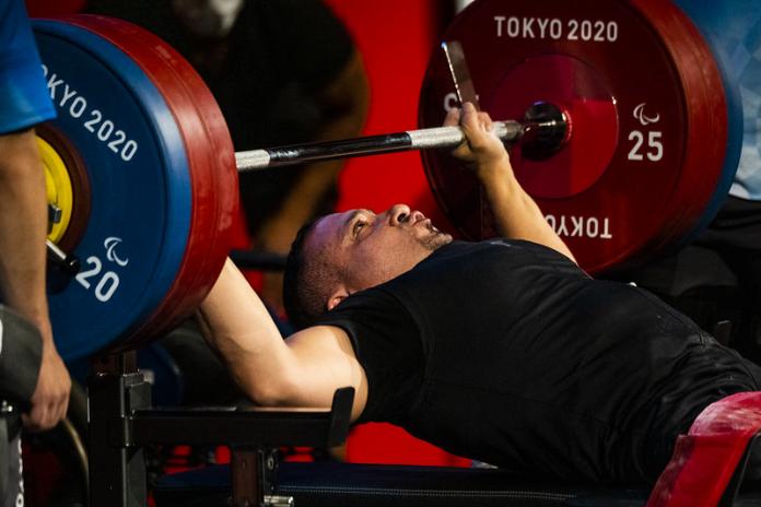 A man preparing to raise a bar on a bench press