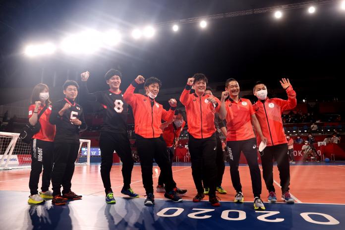 Japanese men's goalball team celebrates on the field of play