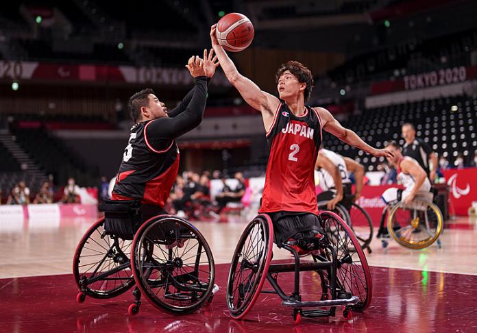 Japanese wheelchair basketball player stretches for the rebound