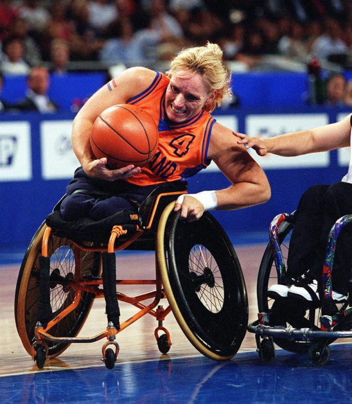 female wheelchair basketball player with the ball